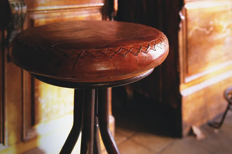 Solid wood and wrought-iron bar stools handcrafted in Jodhpur, India