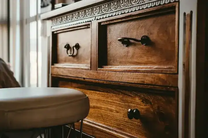 Bold lacquer-finish dresser in solid wood with brass hardware and fretwork
